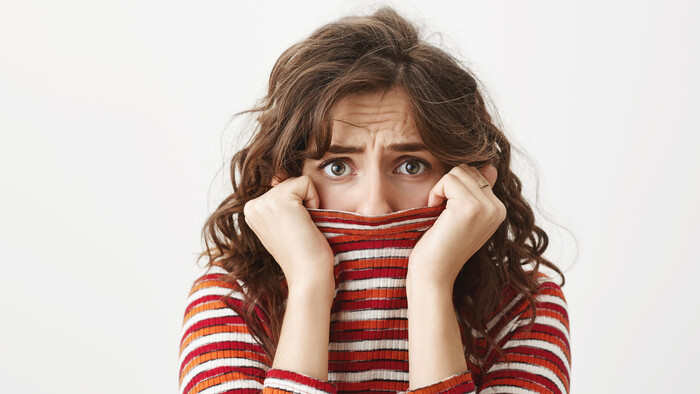 scared-timid-woman-shivering-hiding-face-inside-sweater-collar.jpg